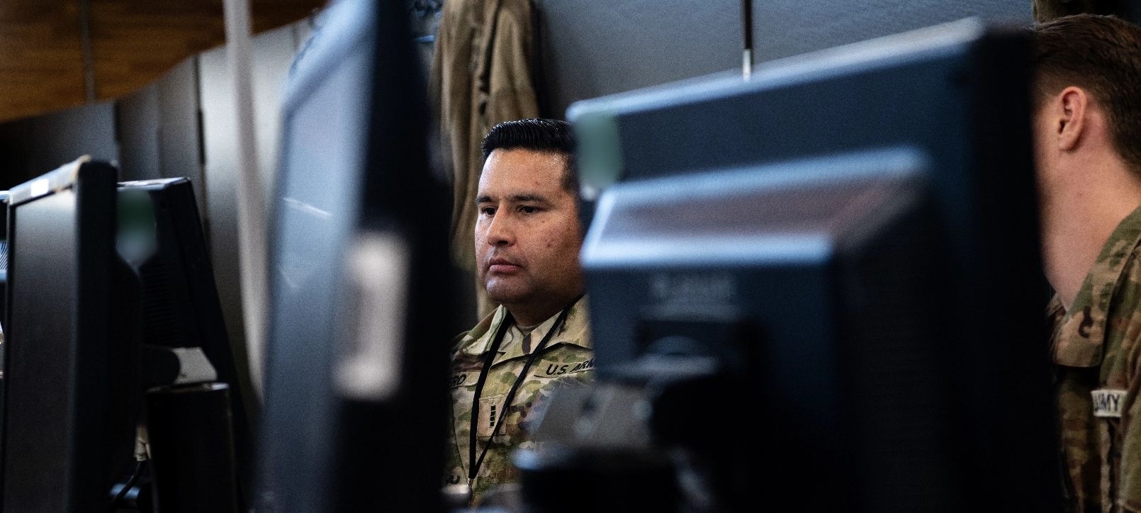 Two soldiers working on a computer.