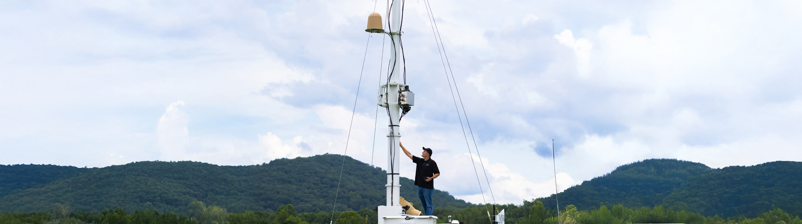 A man stands confidently on the deck of SkyValor.
