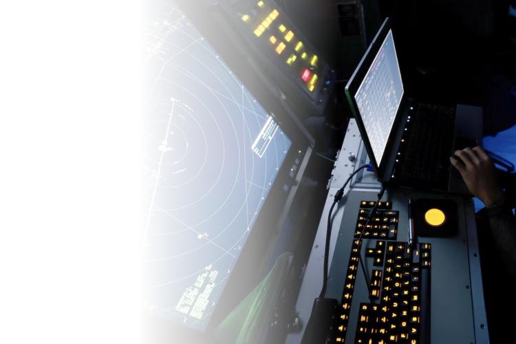 A man focused on his work, seated in front of a computer screen, engaged in a task or activity.