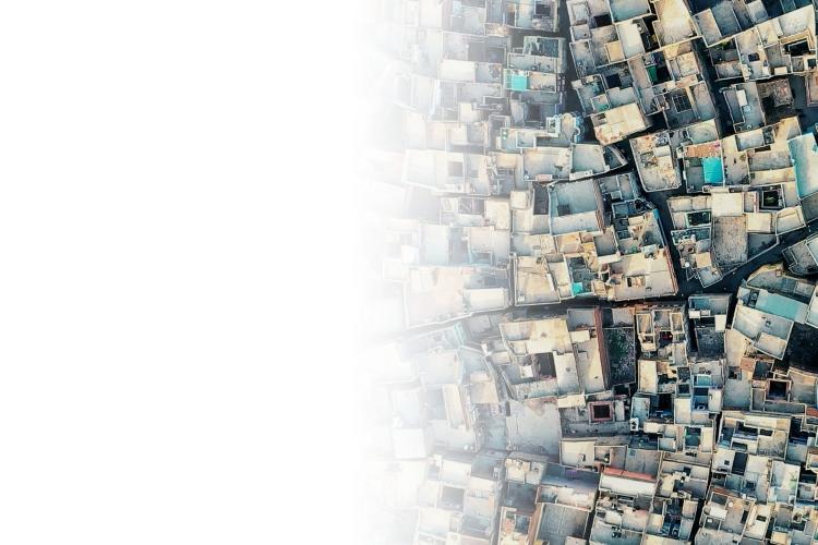 A bustling city skyline featuring numerous tall buildings against a clear blue sky.