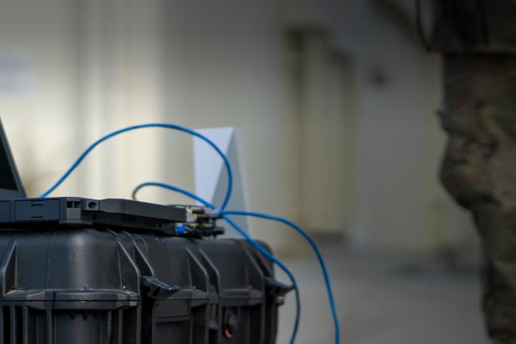 A laptop computer placed on a black case, showcasing a sleek and modern workspace setup.