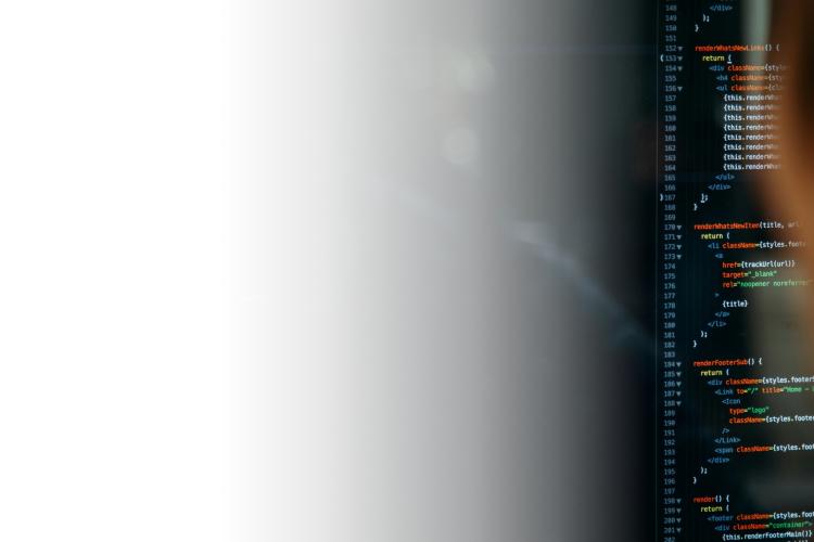 A person focused on a computer screen displaying lines of code, indicating programming or software development work.