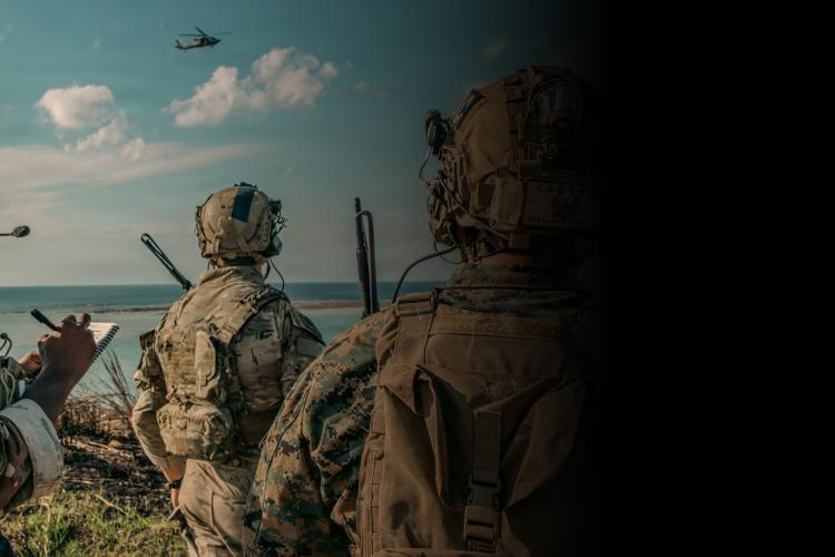 Marines equipped with weapons and gear, standing in formation, ready for deployment in a military setting.