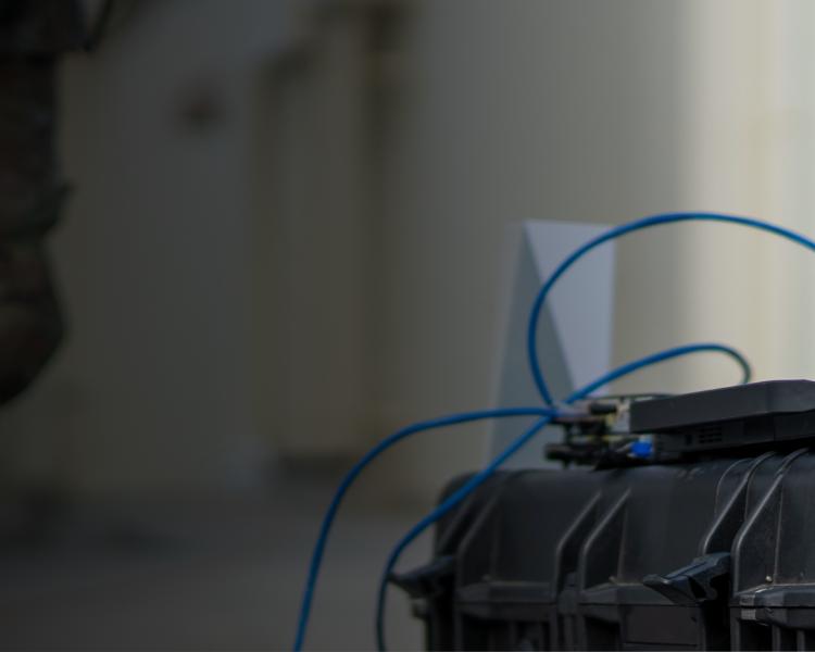 A laptop positioned atop a suitcase, representing the intersection of mobility and digital connectivity.