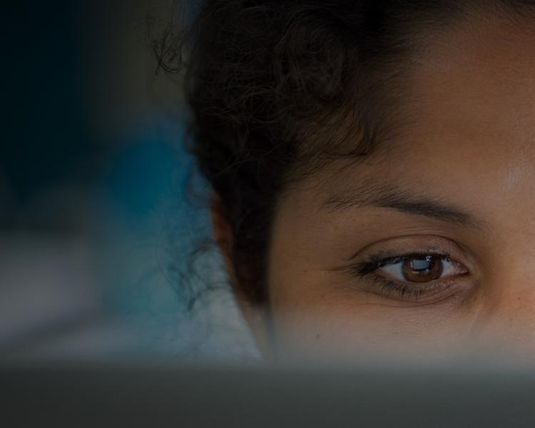 A woman with her eyes closed gazes directly at the camera, conveying a serene and contemplative expression.