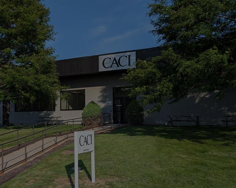 Front view of a building featuring a prominent sign that reads "CACI"