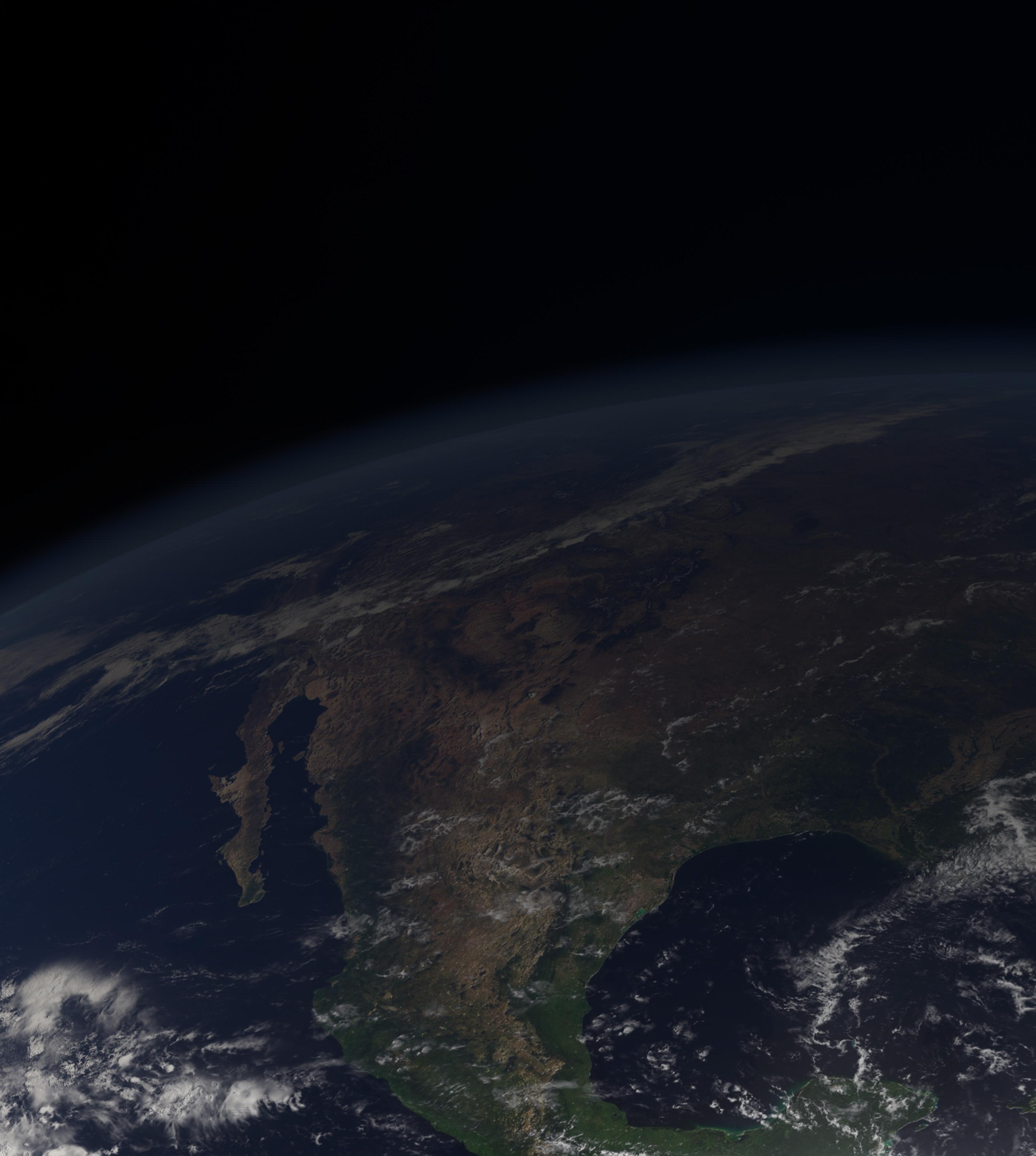 Earth viewed from space, showcasing the Americas and Canada against the backdrop of the dark cosmos.