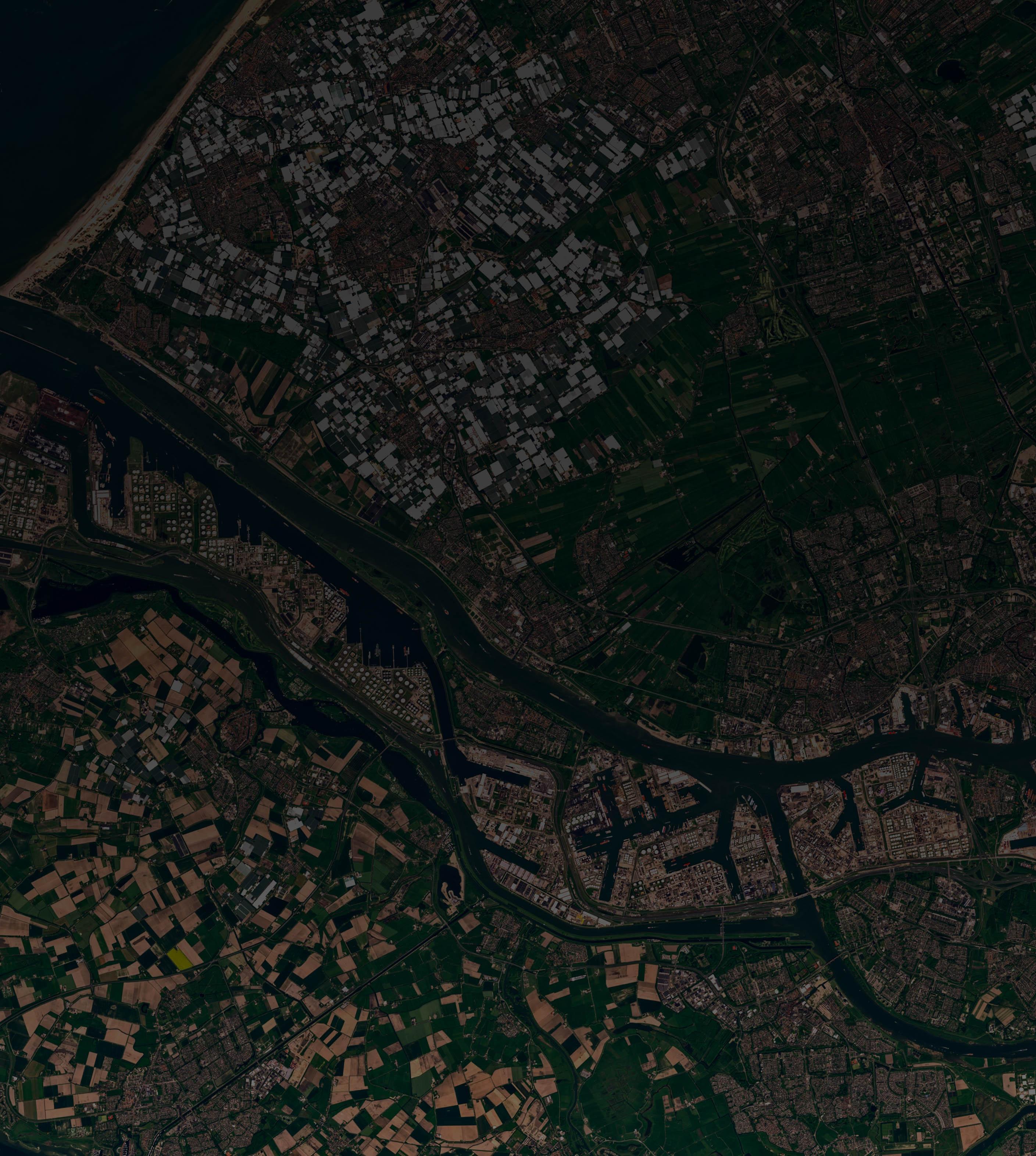 Aerial view showcasing a winding river surrounded by lush green land under a clear blue sky.