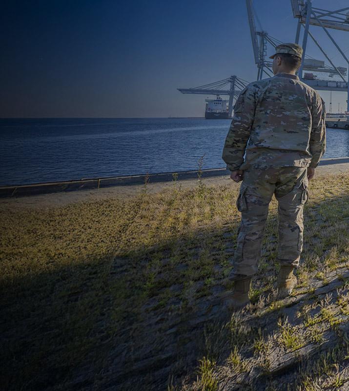 Army soldiers gather on the dock at Newport News, ready for deployment and showcasing military readiness.