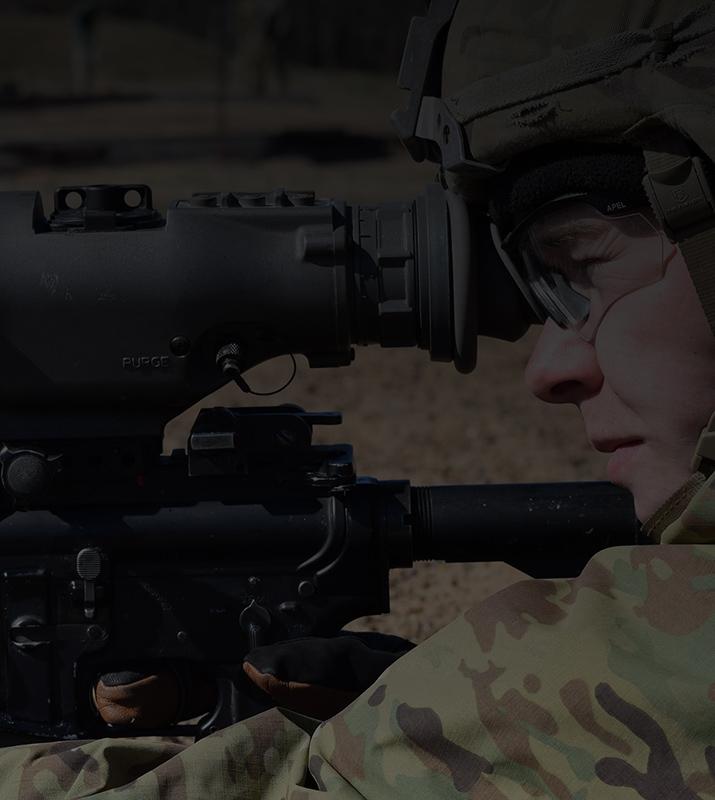 A military personnel looks through a thermal weapon sight during a training exercise.
