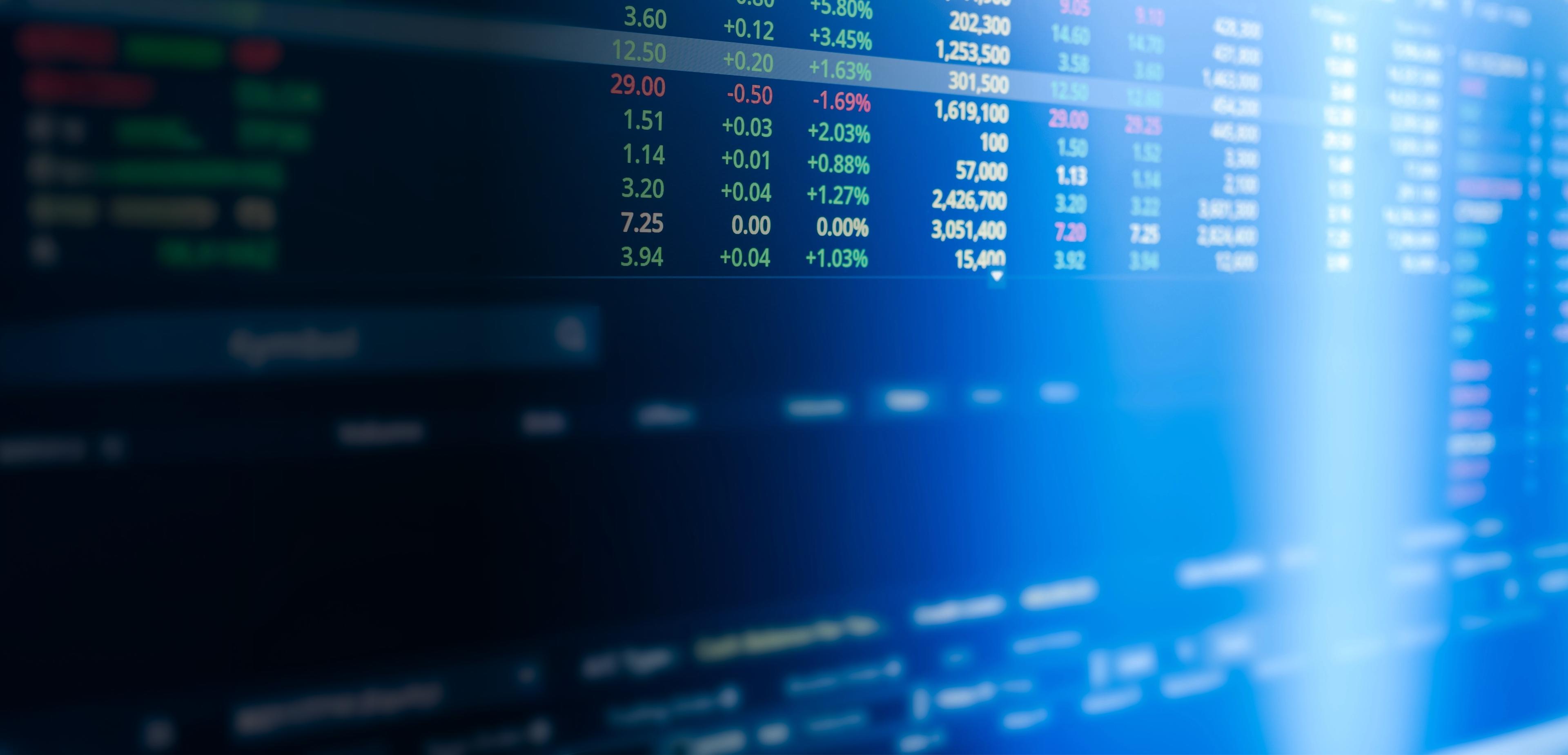 Close-up of a computer screen displaying stock market data with graphs and numerical values.