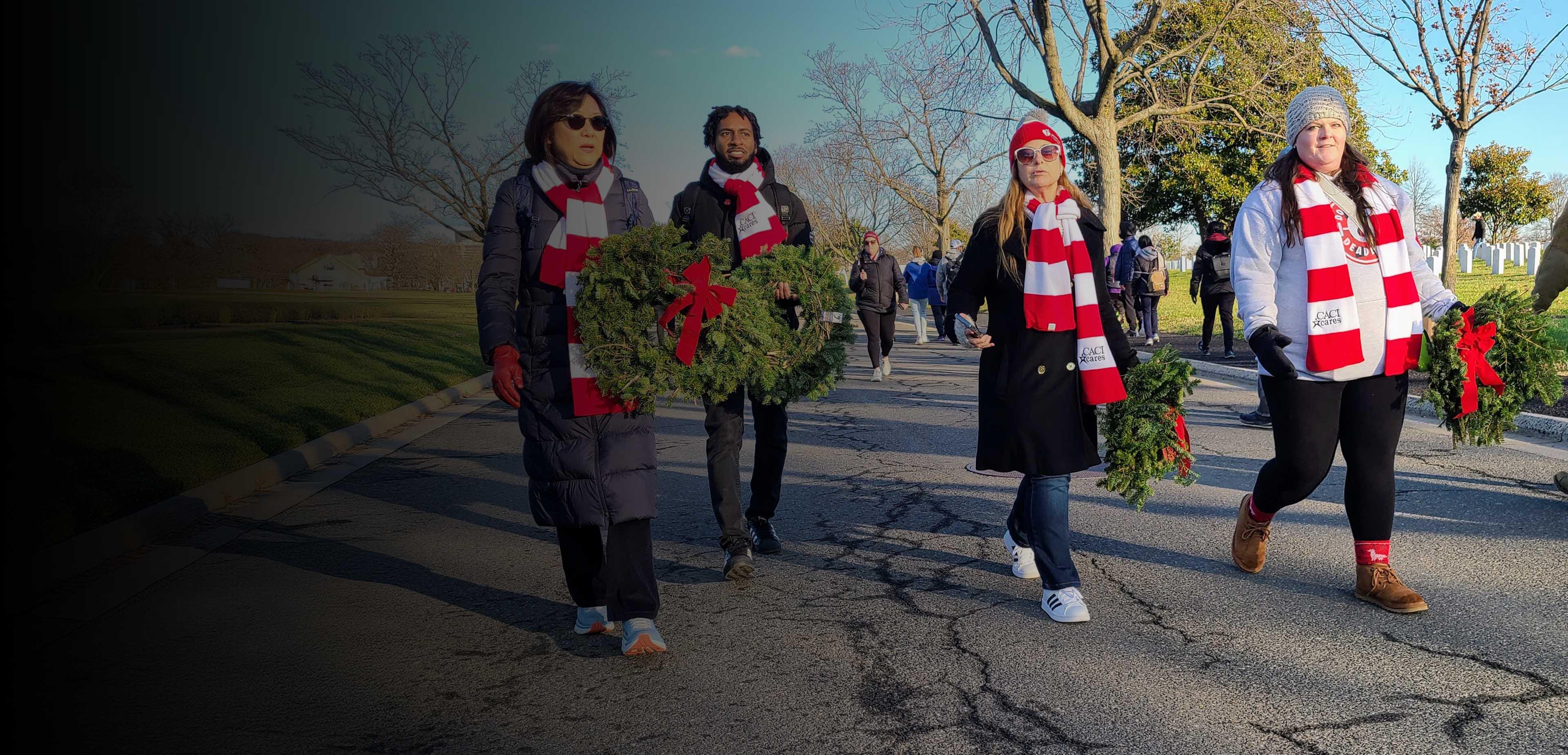 A group of people walking down a road, each carrying a decorative wreath in their hands.