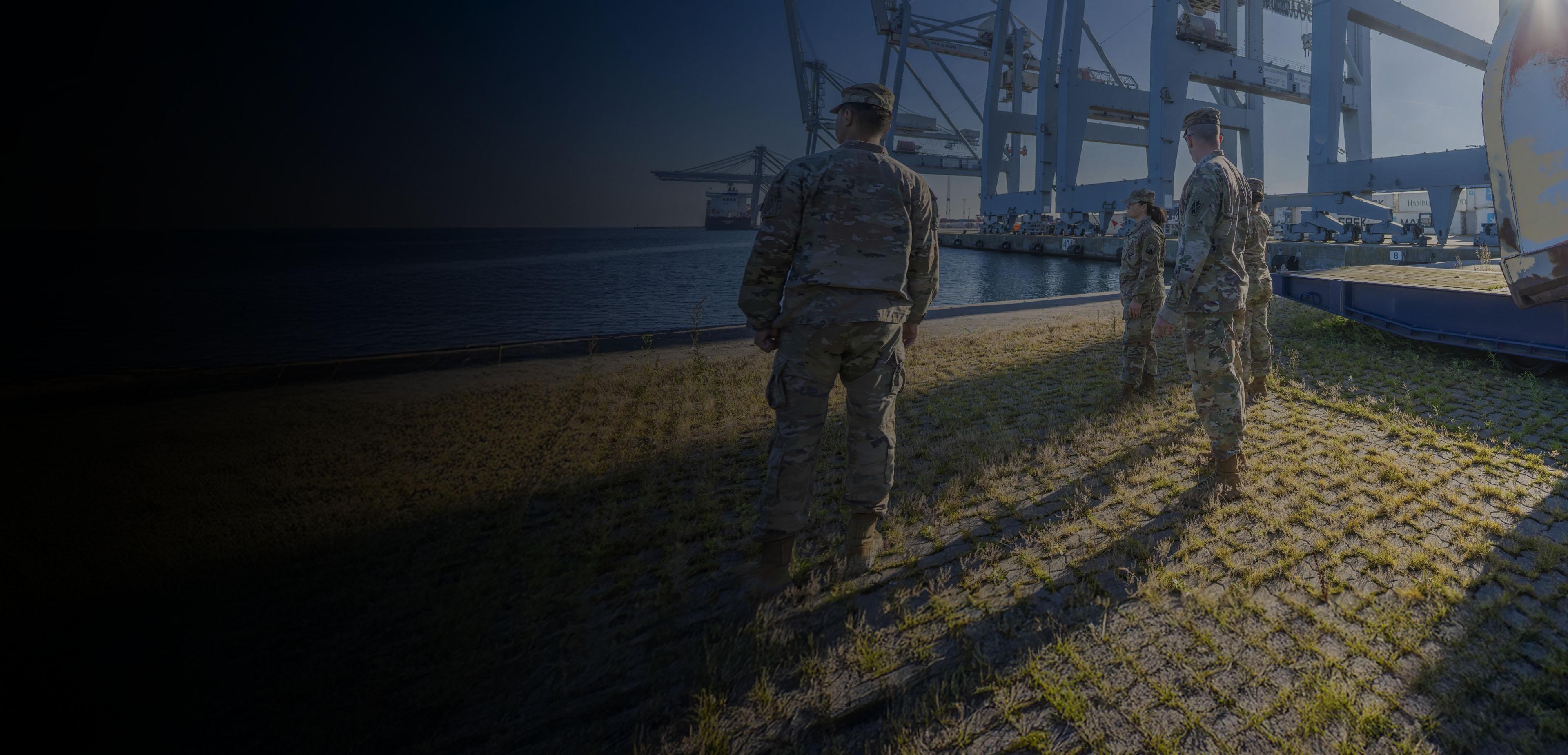 Army soldiers gather on the dock at Newport News, ready for deployment and showcasing military readiness.
