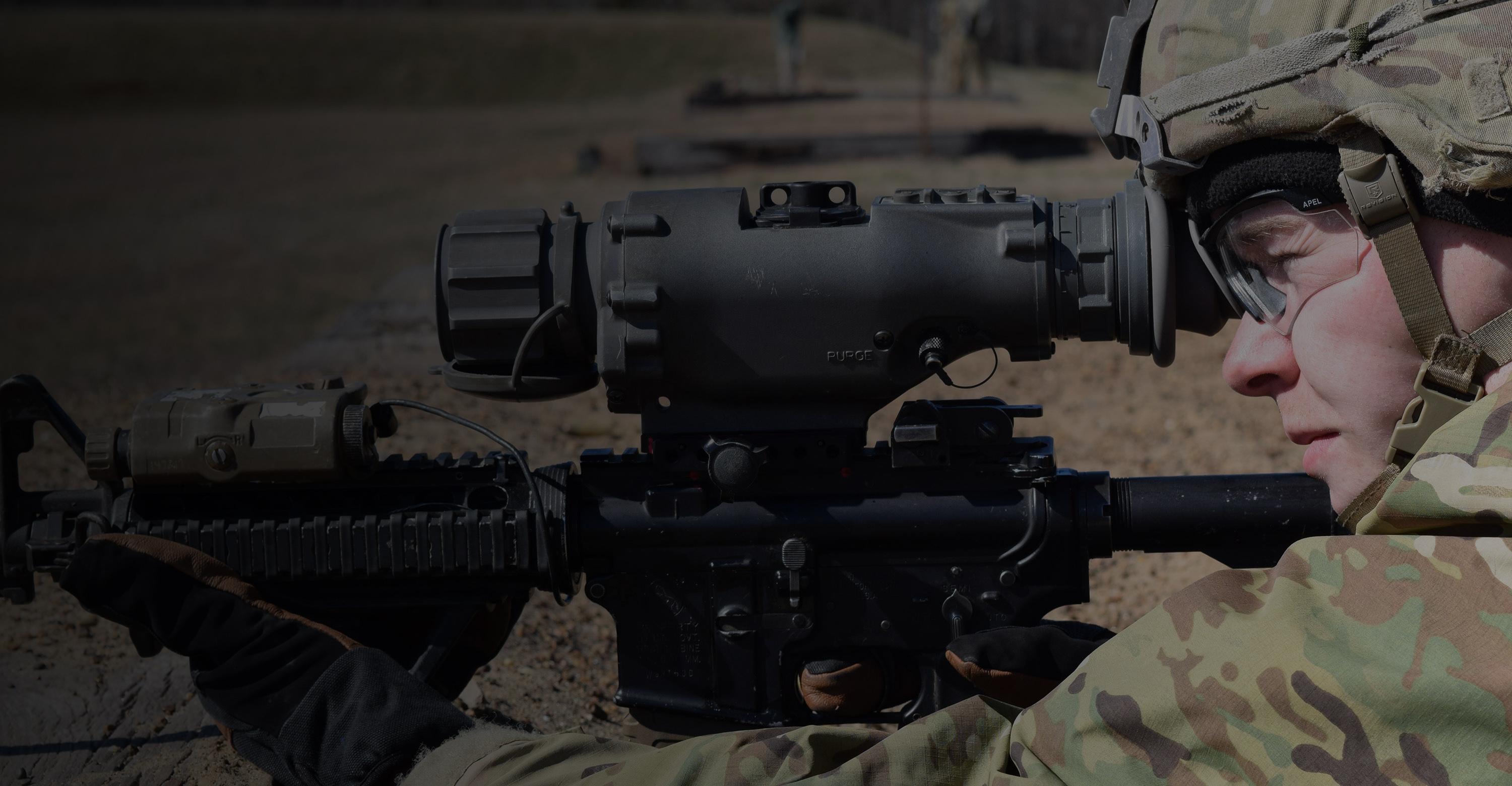 A military personnel looks through a thermal weapon sight during a training exercise.
