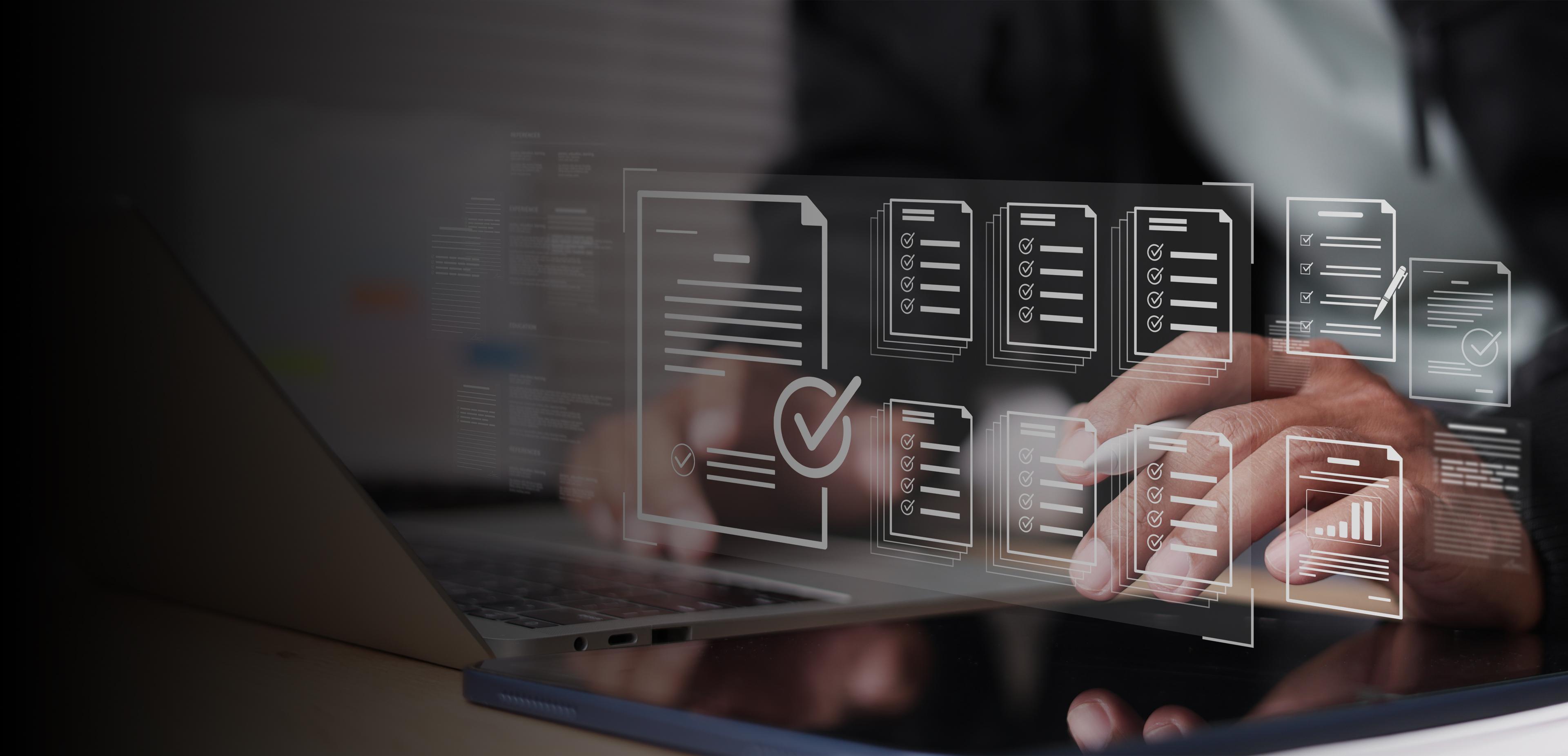 Hands working on a laptop beneath translucent digital checklists, documents, and charts, suggesting focused online review and organized data management.