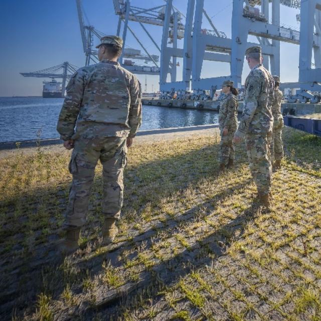 Army soldiers gather on the dock at Newport News, ready for deployment and showcasing military readiness.