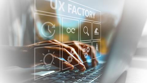 Hands typing on a laptop keyboard with a digital overlay reading "UX Factory" and icons symbolizing various UX concepts.